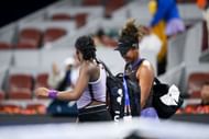 Coco Gauff (L) helping Naomi Osaka (R) carry her bags after the Japanese player's mid-match retirement in the fourth round at the 2024 China Open (Source: Getty)
